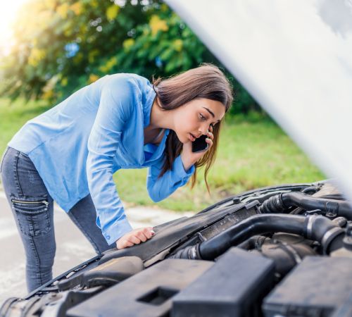 Woman checking her car engine