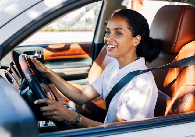 Smiling woman driving her car