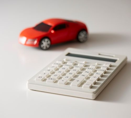 Toy car beside a calculator